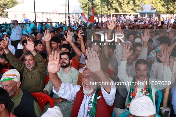 People raise slogans in favor of Rahul Gandhi during his visit to Sopore to campaign for his candidates for Assembly elections in Jammu and...