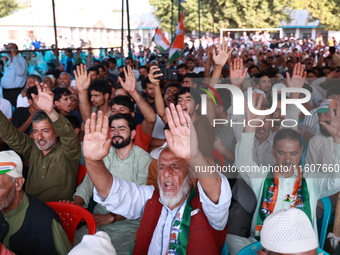 People raise slogans in favor of Rahul Gandhi during his visit to Sopore to campaign for his candidates for Assembly elections in Jammu and...