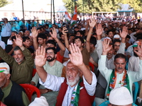 People raise slogans in favor of Rahul Gandhi during his visit to Sopore to campaign for his candidates for Assembly elections in Jammu and...