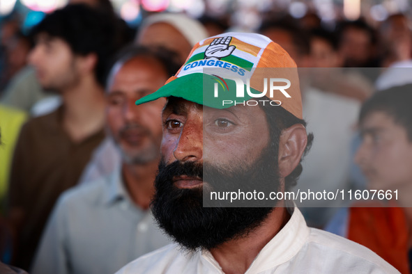 People raise slogans in favor of Rahul Gandhi during his visit to Sopore to campaign for his candidates for Assembly elections in Jammu and...