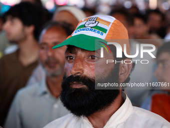 People raise slogans in favor of Rahul Gandhi during his visit to Sopore to campaign for his candidates for Assembly elections in Jammu and...