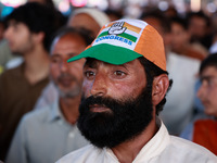 People raise slogans in favor of Rahul Gandhi during his visit to Sopore to campaign for his candidates for Assembly elections in Jammu and...