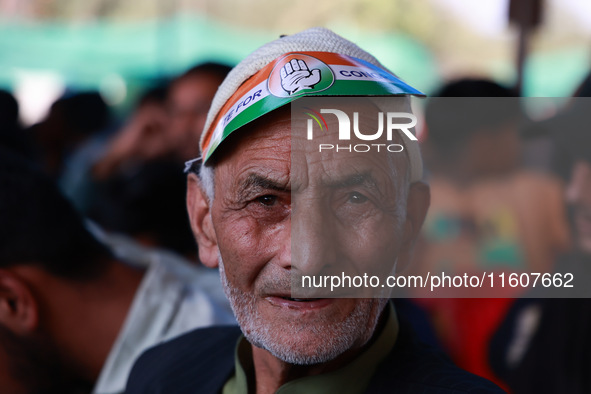 People raise slogans in favor of Rahul Gandhi during his visit to Sopore to campaign for his candidates for Assembly elections in Jammu and...