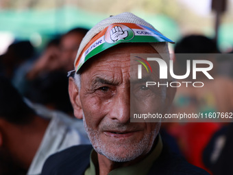 People raise slogans in favor of Rahul Gandhi during his visit to Sopore to campaign for his candidates for Assembly elections in Jammu and...