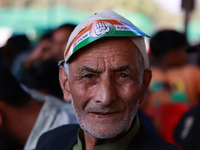 People raise slogans in favor of Rahul Gandhi during his visit to Sopore to campaign for his candidates for Assembly elections in Jammu and...