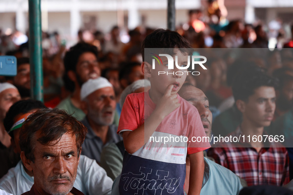 People raise slogans in favor of Rahul Gandhi during his visit to Sopore to campaign for his candidates for Assembly elections in Jammu and...