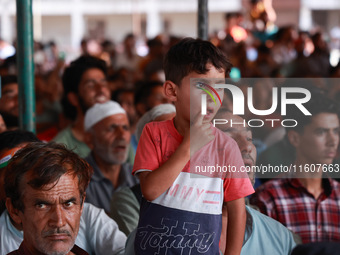 People raise slogans in favor of Rahul Gandhi during his visit to Sopore to campaign for his candidates for Assembly elections in Jammu and...