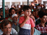 People raise slogans in favor of Rahul Gandhi during his visit to Sopore to campaign for his candidates for Assembly elections in Jammu and...