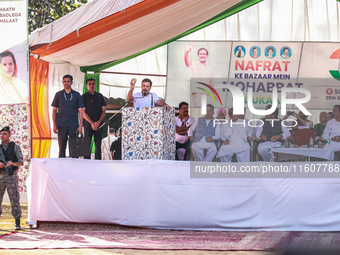 Rahul Gandhi holds a Kashmiri apple while addressing the public ahead of phase 3 assembly elections in Sopore, Jammu and Kashmir, India, on...