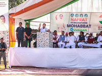 Rahul Gandhi holds a Kashmiri apple while addressing the public ahead of phase 3 assembly elections in Sopore, Jammu and Kashmir, India, on...