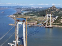 The installation and construction of suspension cables at the construction site of Rushankou Cross Sea Bridge take place in Weihai, China, o...