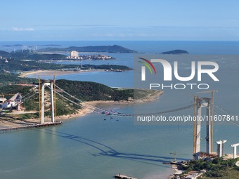 The installation and construction of suspension cables at the construction site of Rushankou Cross Sea Bridge take place in Weihai, China, o...