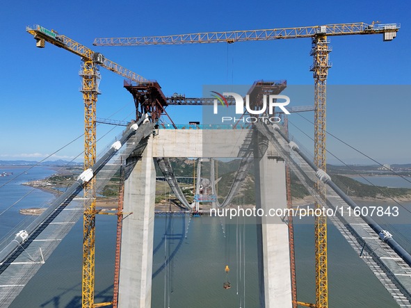 The installation and construction of suspension cables at the construction site of Rushankou Cross Sea Bridge take place in Weihai, China, o...