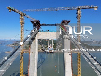 The installation and construction of suspension cables at the construction site of Rushankou Cross Sea Bridge take place in Weihai, China, o...