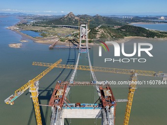 The installation and construction of suspension cables at the construction site of Rushankou Cross Sea Bridge take place in Weihai, China, o...