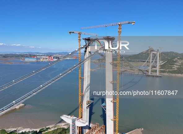 The installation and construction of suspension cables at the construction site of Rushankou Cross Sea Bridge take place in Weihai, China, o...