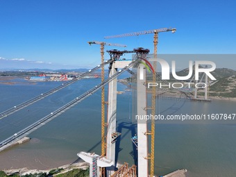 The installation and construction of suspension cables at the construction site of Rushankou Cross Sea Bridge take place in Weihai, China, o...