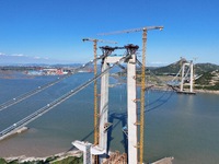 The installation and construction of suspension cables at the construction site of Rushankou Cross Sea Bridge take place in Weihai, China, o...