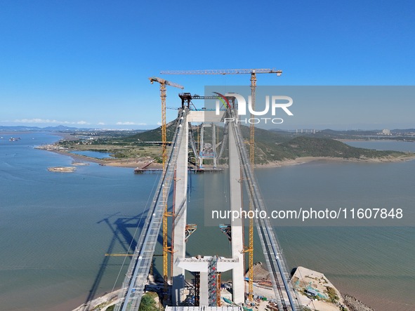 The installation and construction of suspension cables at the construction site of Rushankou Cross Sea Bridge take place in Weihai, China, o...