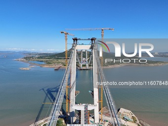 The installation and construction of suspension cables at the construction site of Rushankou Cross Sea Bridge take place in Weihai, China, o...