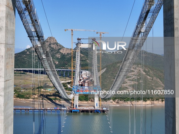 The installation and construction of suspension cables at the construction site of Rushankou Cross Sea Bridge take place in Weihai, China, o...