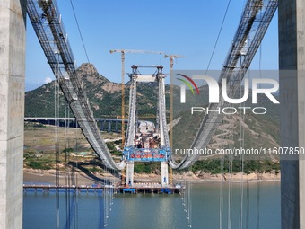 The installation and construction of suspension cables at the construction site of Rushankou Cross Sea Bridge take place in Weihai, China, o...