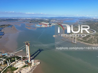 The installation and construction of suspension cables at the construction site of Rushankou Cross Sea Bridge take place in Weihai, China, o...