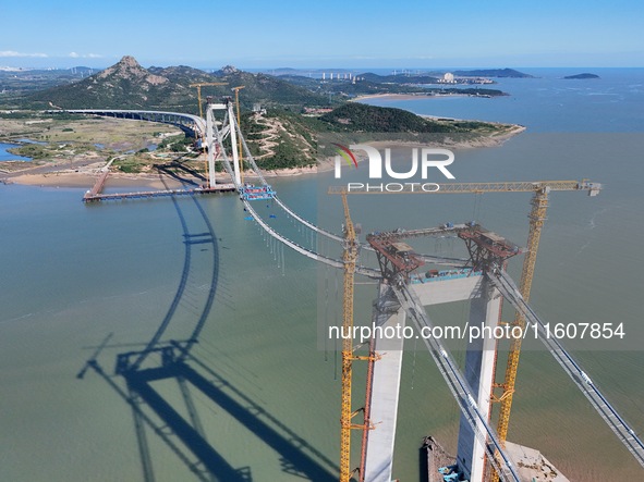 The installation and construction of suspension cables at the construction site of Rushankou Cross Sea Bridge take place in Weihai, China, o...