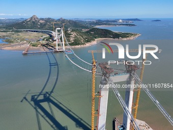 The installation and construction of suspension cables at the construction site of Rushankou Cross Sea Bridge take place in Weihai, China, o...