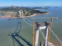 The installation and construction of suspension cables at the construction site of Rushankou Cross Sea Bridge take place in Weihai, China, o...