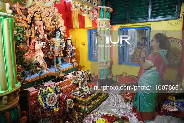 A devotee offers prayer before performing rituals to the idol of Hindu goddess Durga inside their house, the Hindu goddess of power, ahead o...