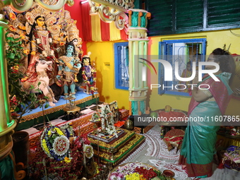 A devotee offers prayer before performing rituals to the idol of Hindu goddess Durga inside their house, the Hindu goddess of power, ahead o...