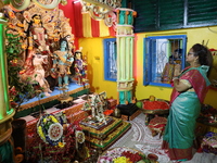 A devotee offers prayer before performing rituals to the idol of Hindu goddess Durga inside their house, the Hindu goddess of power, ahead o...