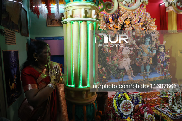 A devotee offers prayer before performing rituals to the idol of Hindu goddess Durga inside their house, the Hindu goddess of power, ahead o...