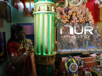 A devotee offers prayer before performing rituals to the idol of Hindu goddess Durga inside their house, the Hindu goddess of power, ahead o...