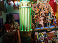 A devotee offers prayer before performing rituals to the idol of Hindu goddess Durga inside their house, the Hindu goddess of power, ahead o...