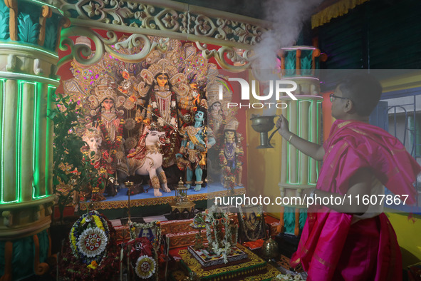 A devotee performs rituals to the idol of the Hindu goddess Durga inside their house, the Hindu goddess of power, ahead of the Durga Puja fe...