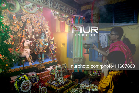 Devotees perform rituals to the idol of the Hindu goddess Durga inside their house, the Hindu goddess of power, ahead of the Durga Puja fest...