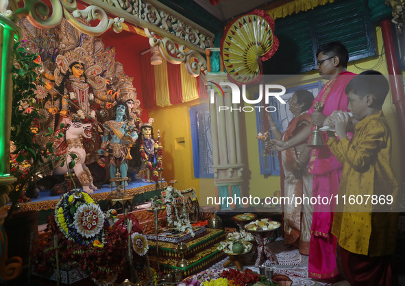 Devotees perform rituals to the idol of the Hindu goddess Durga inside their house, the Hindu goddess of power, ahead of the Durga Puja fest...