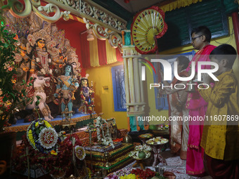 Devotees perform rituals to the idol of the Hindu goddess Durga inside their house, the Hindu goddess of power, ahead of the Durga Puja fest...