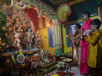 Devotees perform rituals to the idol of the Hindu goddess Durga inside their house, the Hindu goddess of power, ahead of the Durga Puja fest...