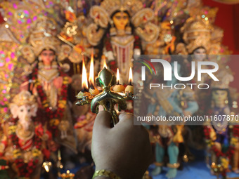 A devotee performs rituals to the idol of the Hindu goddess Durga inside their house, the Hindu goddess of power, ahead of the Durga Puja fe...