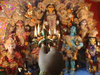 A devotee performs rituals to the idol of the Hindu goddess Durga inside their house, the Hindu goddess of power, ahead of the Durga Puja fe...