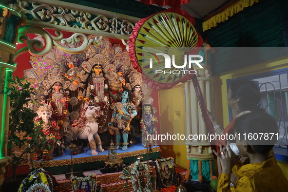 Devotees perform rituals to the idol of the Hindu goddess Durga inside their house, the Hindu goddess of power, ahead of the Durga Puja fest...