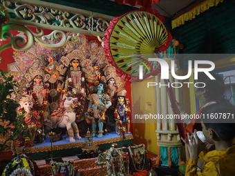 Devotees perform rituals to the idol of the Hindu goddess Durga inside their house, the Hindu goddess of power, ahead of the Durga Puja fest...