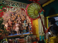 Devotees perform rituals to the idol of the Hindu goddess Durga inside their house, the Hindu goddess of power, ahead of the Durga Puja fest...