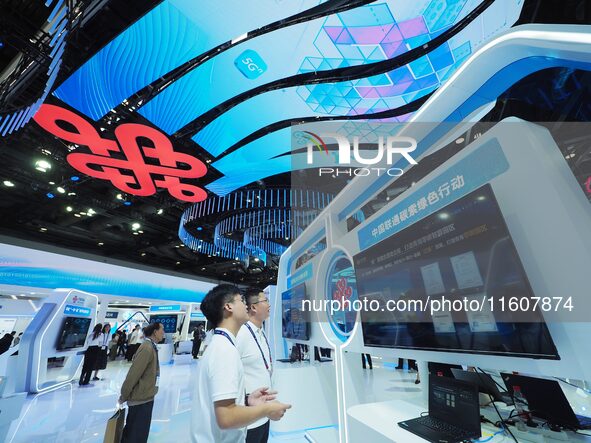 Visitors visit the case of ''Low carbon computing power'' at the booth of China Unicom at the China International Information and Communicat...