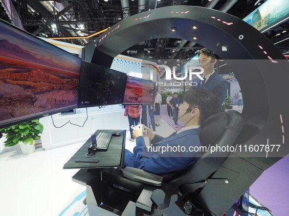 Visitors experience ''Tianyi Yunyun e-sports'' at the booth of China Telecom at the 2024 China International Information and Communications...