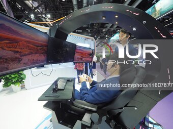 Visitors experience ''Tianyi Yunyun e-sports'' at the booth of China Telecom at the 2024 China International Information and Communications...