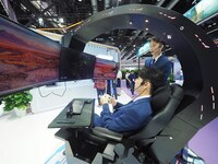 Visitors experience ''Tianyi Yunyun e-sports'' at the booth of China Telecom at the 2024 China International Information and Communications...